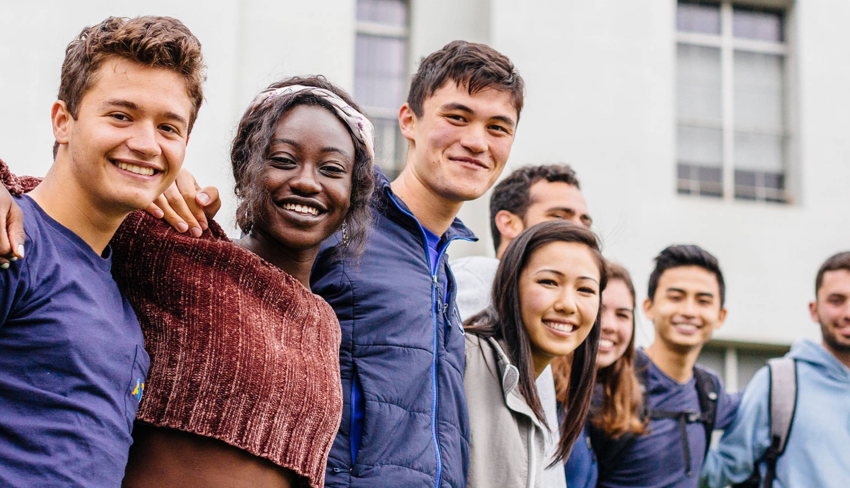 Large group of students posing together on campus