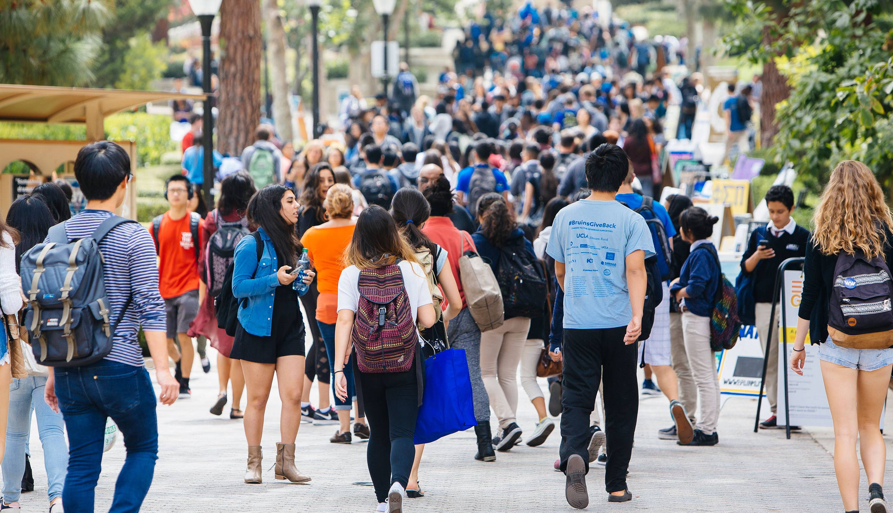 Lots of students walking on a walking path on campus