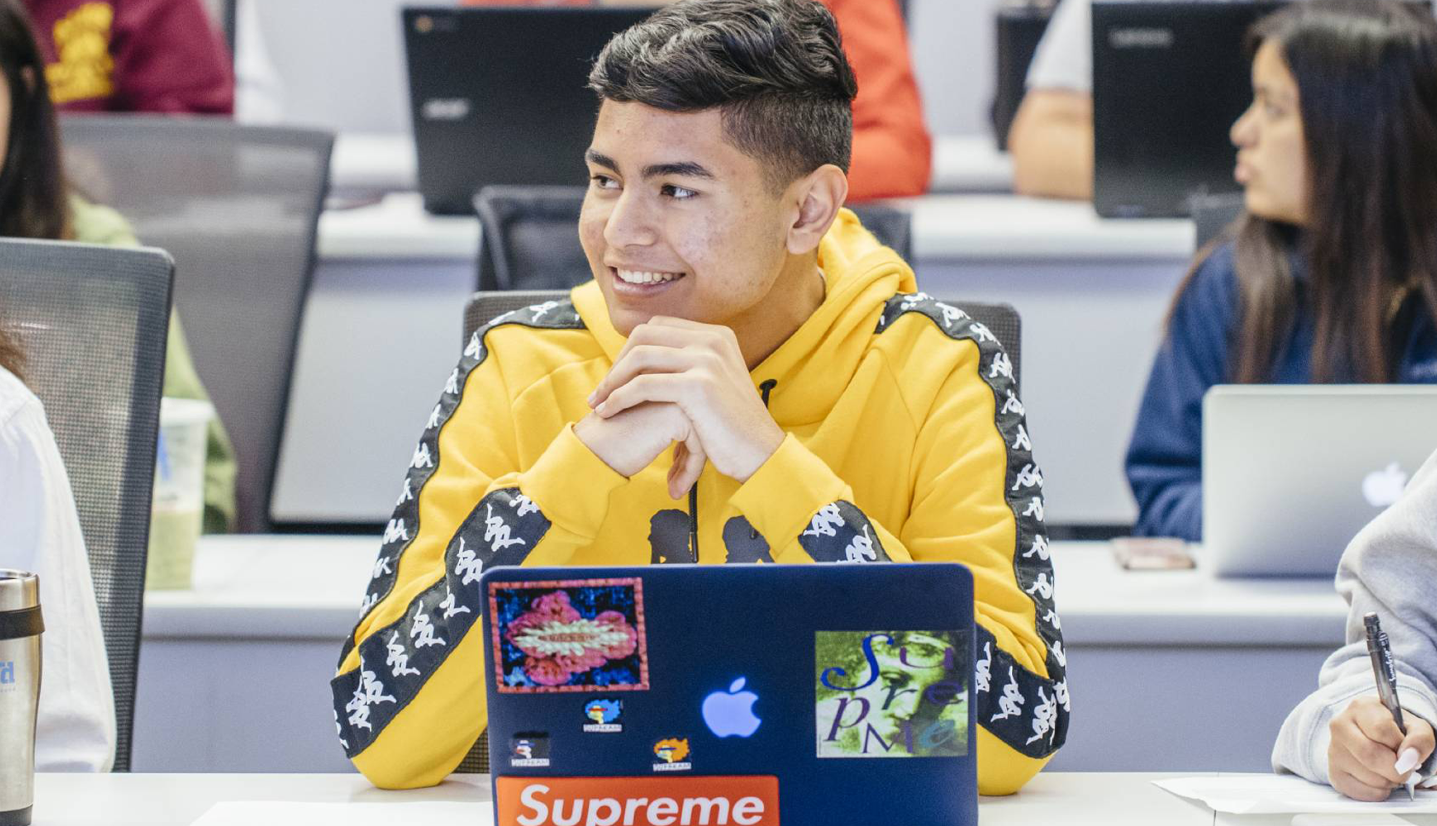 Students in a classroom with laptops. 