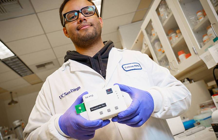 Bioengineering senior Armando Ramil holds the biosensor.