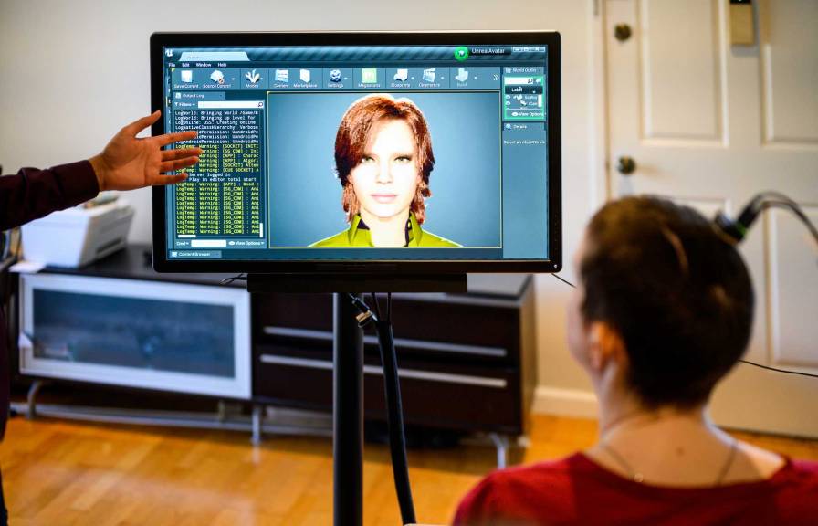 Computer screen with a woman in front with brain implant.