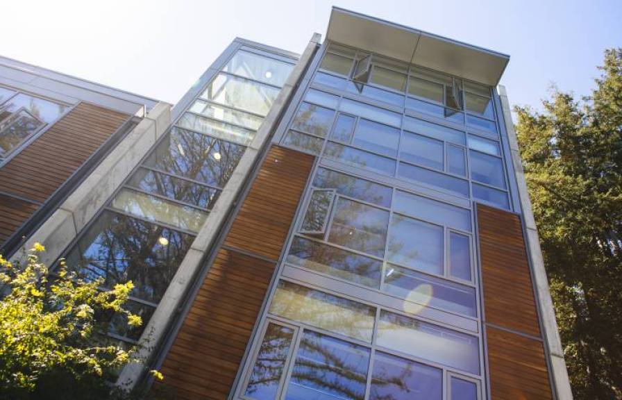 Modern building with glass and wood paneling. 