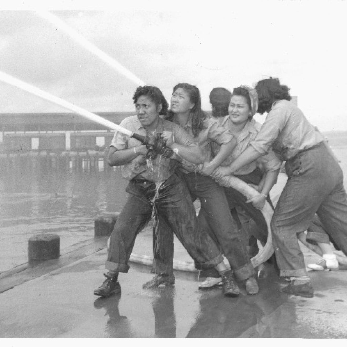 Women training with fire hose at Pearl Harbor Naval Shipyard.
