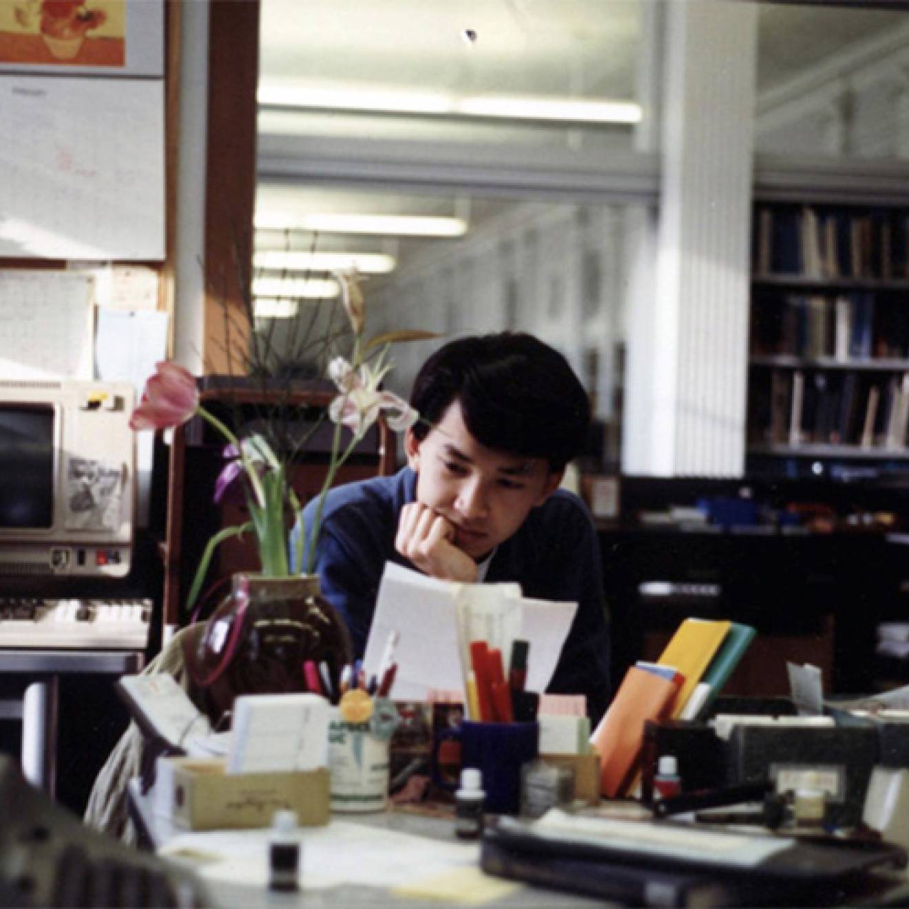 Viet Thanh Nguyen reading a paper in the library as a student at UC Berkeley