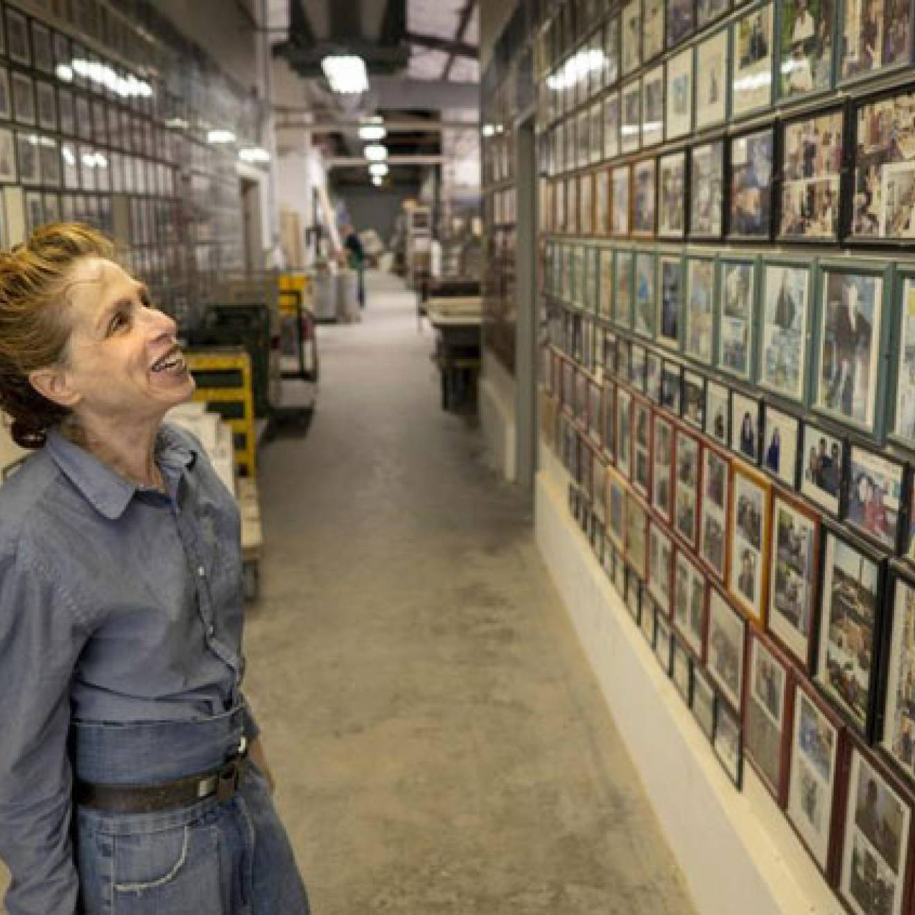 Annabeth Rosen looks at a wall of pictures