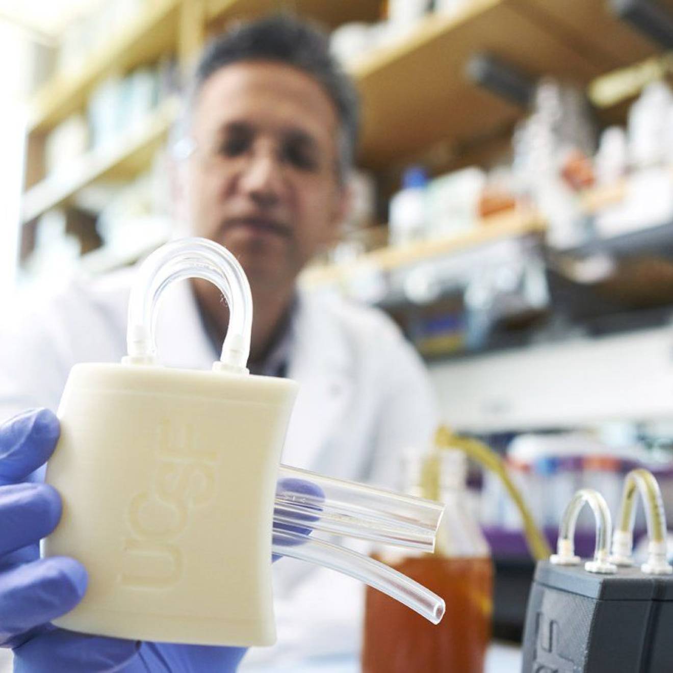 A researcher holding a piece of medical equipment