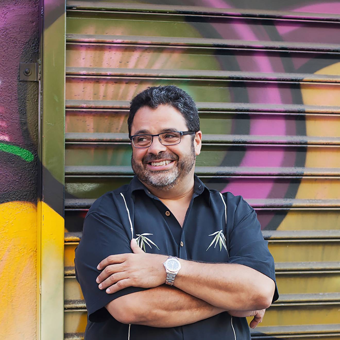Arturo O’Farrill in front of a mural