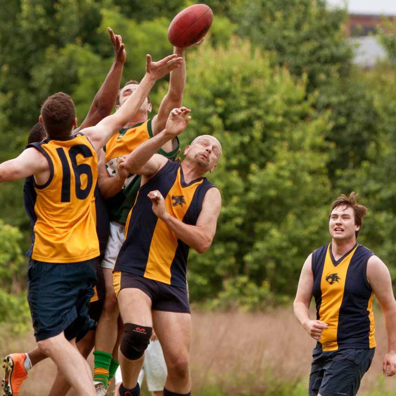 Australian football players collide over ball