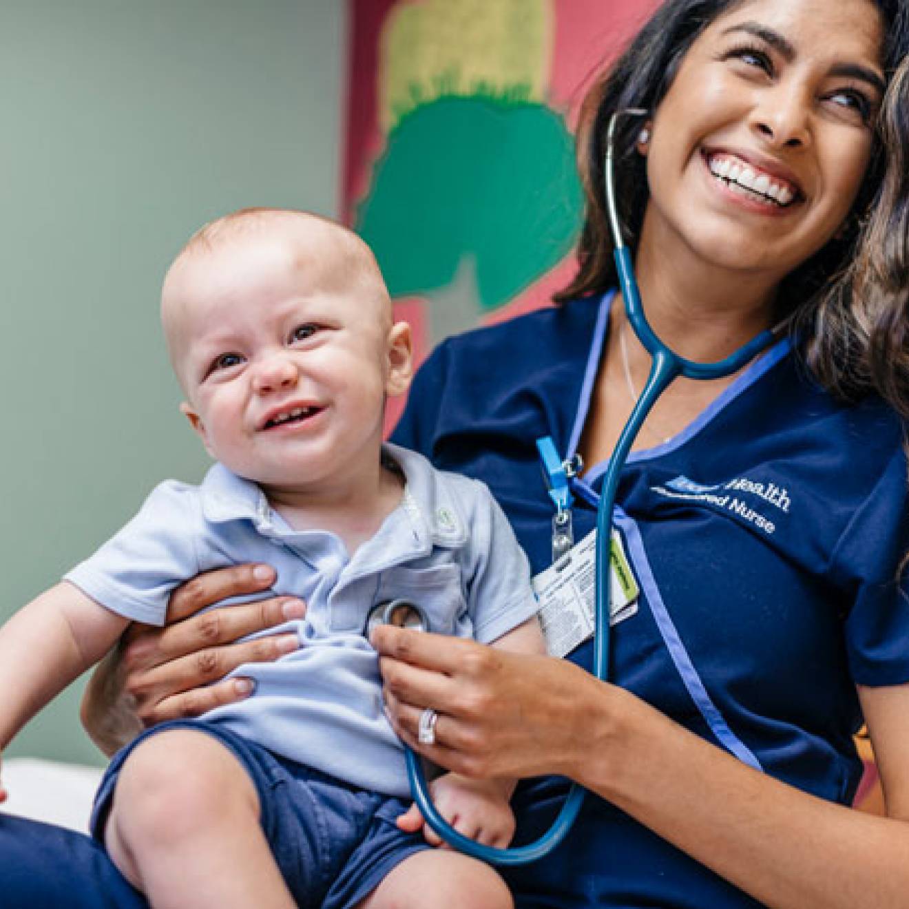 Nurse smiling with a baby