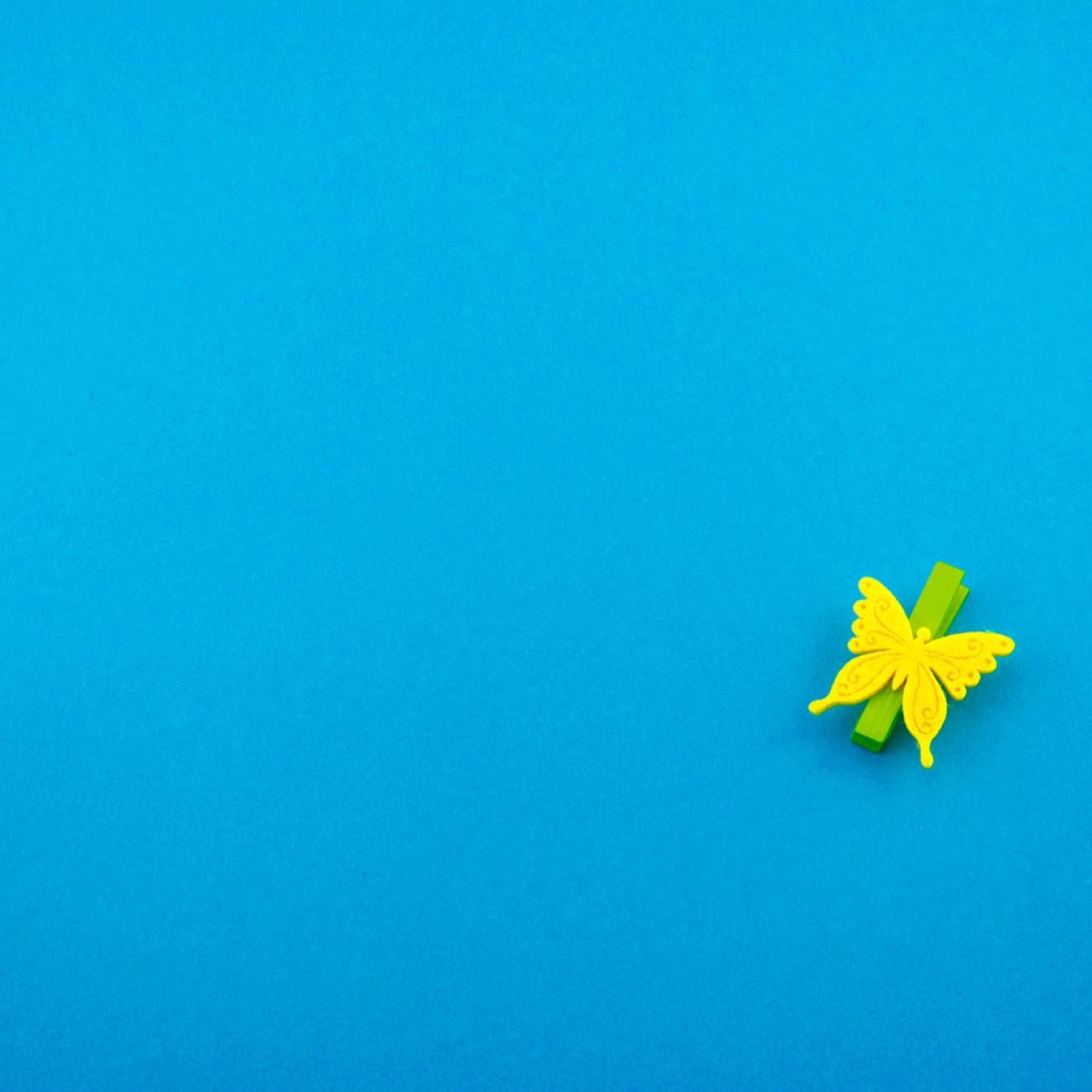 Yellow paper butterfly on blue background