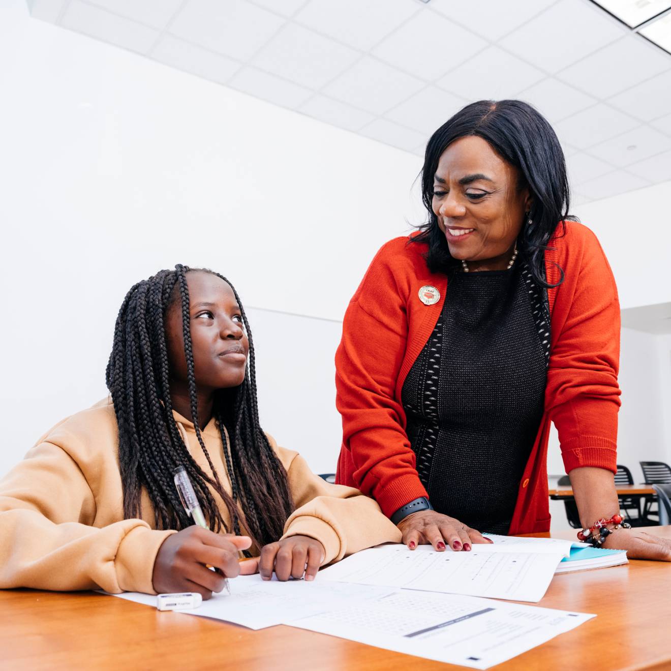 Ingrid Johnson, founder of CAAP, talks to a student taking a test in a classroom