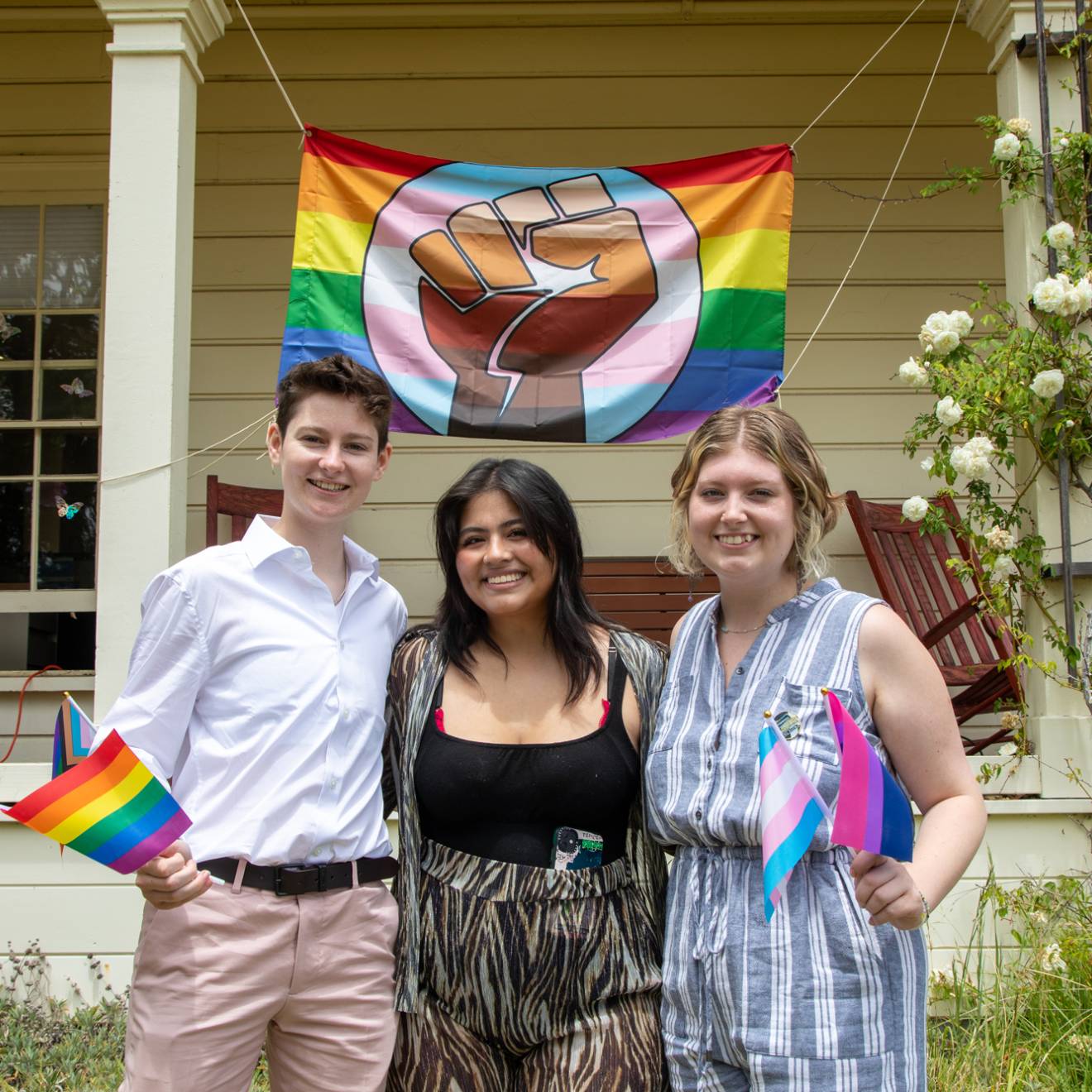 Three people in front of Lionel Cantú Queer Resource Center porch