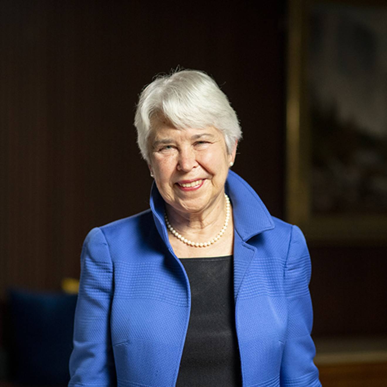 UC Berkeley Chancellor Carol Christ, smiling woman with short white hair, in blue jacket