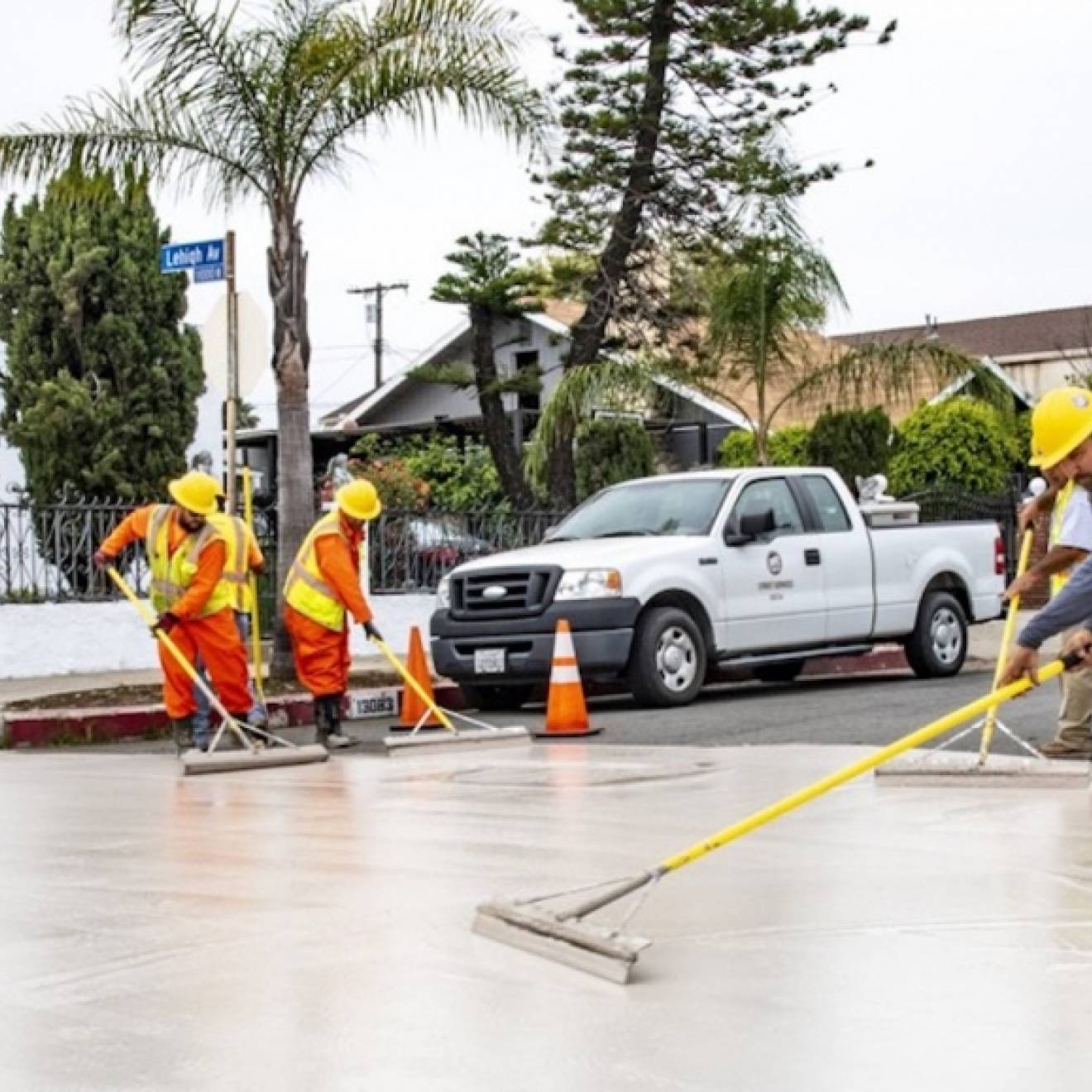 Workers applying cool pavement