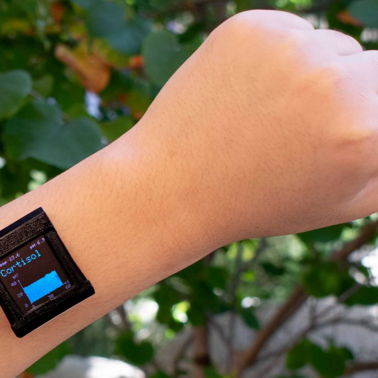 A smart watch on a wrist with cortisol reading displayed