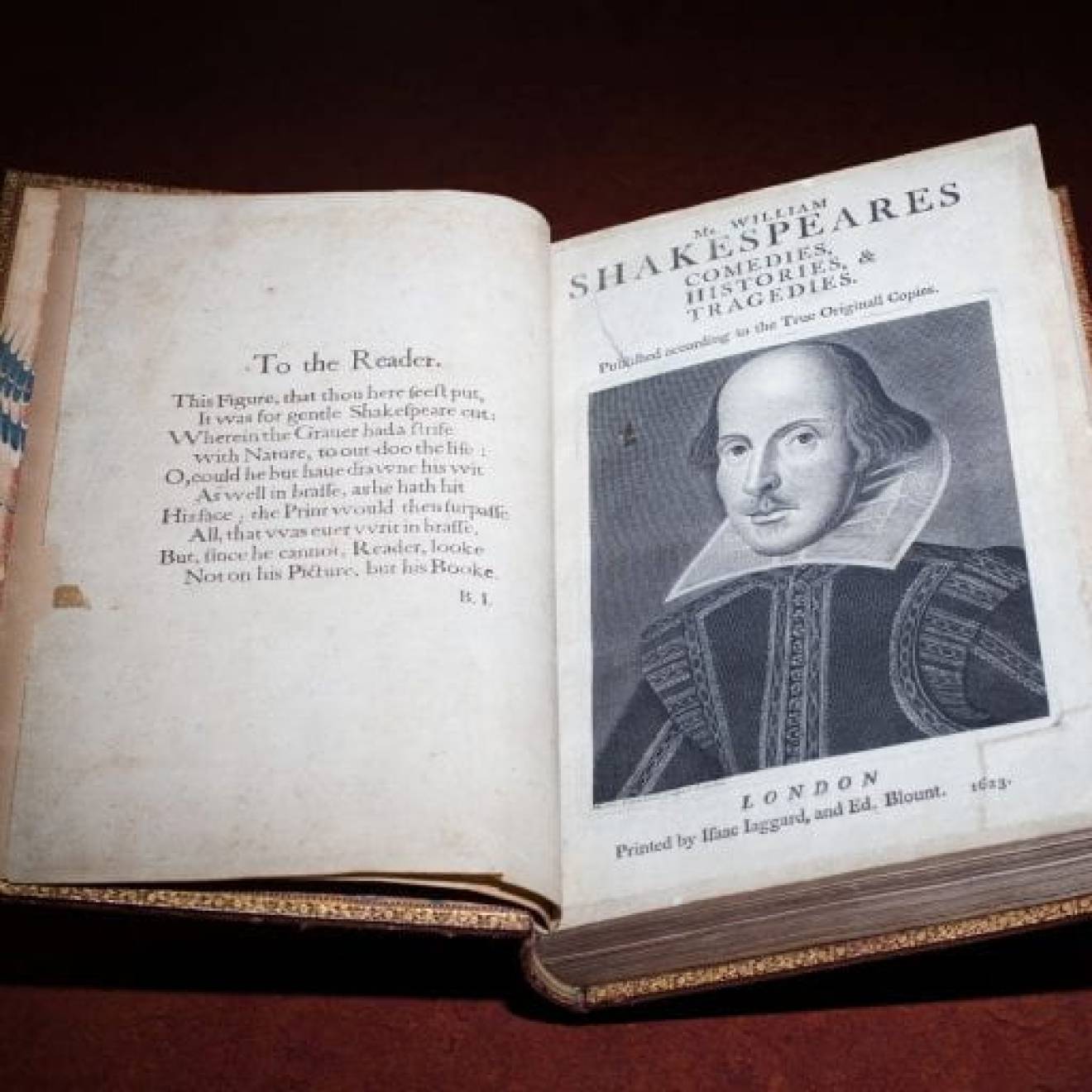 First Folio collection of Shakespeare plays with text on the left page and a portrait of Shakespeare on the right
