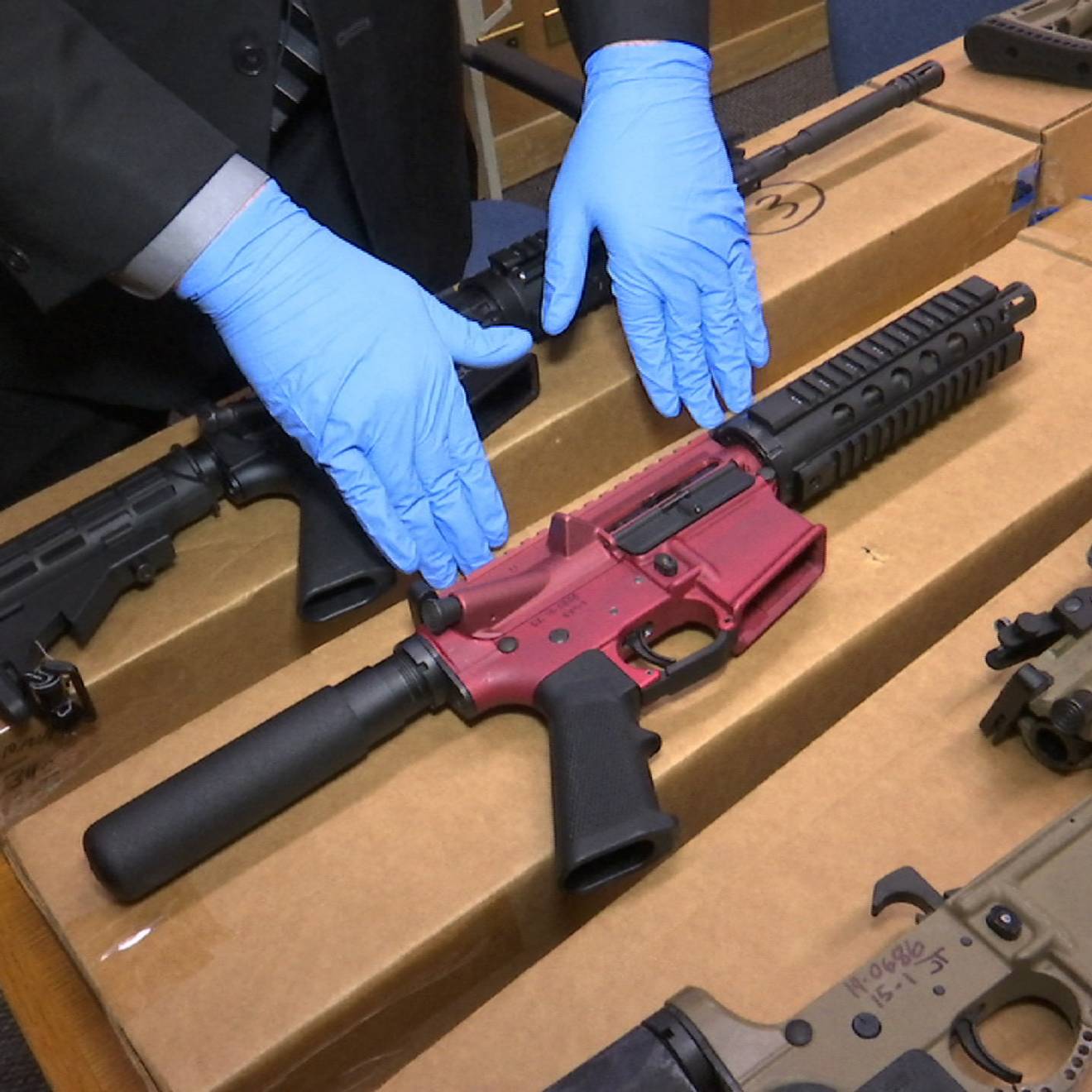 A San Franciso police officer displays several ‘ghost guns’ – untraceable firearms with no serial numbers or manufacturing marks. 