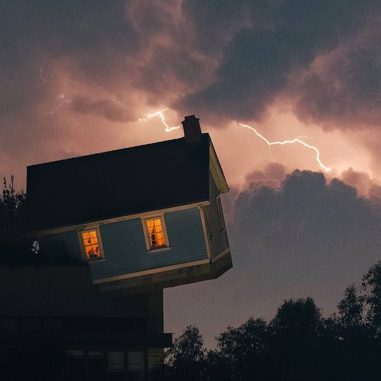 Halloween science The leaning/falling house installation on the UC San Diego campus with a lightning sky backdrop