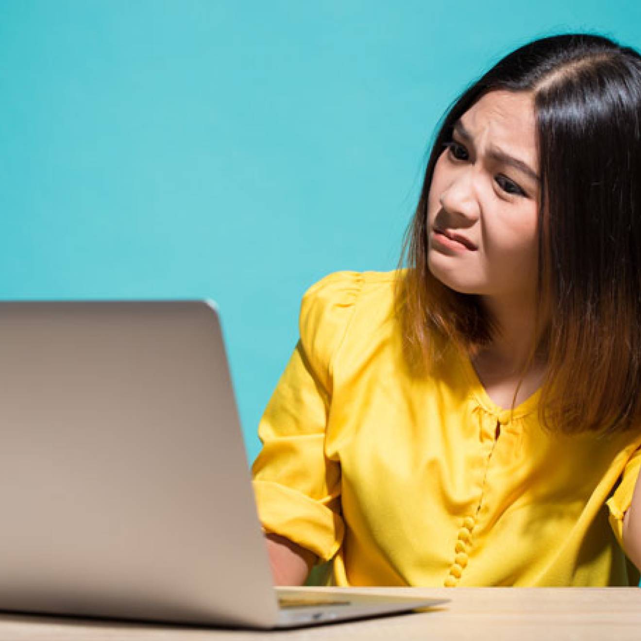 Woman reading fake news on her laptop