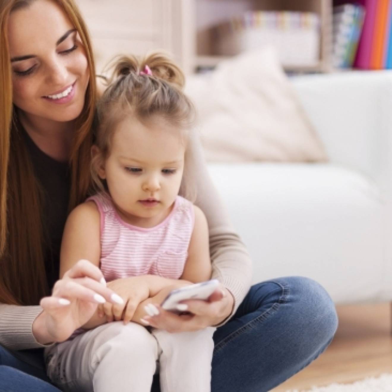 Mom and toddler looking at a cell phone