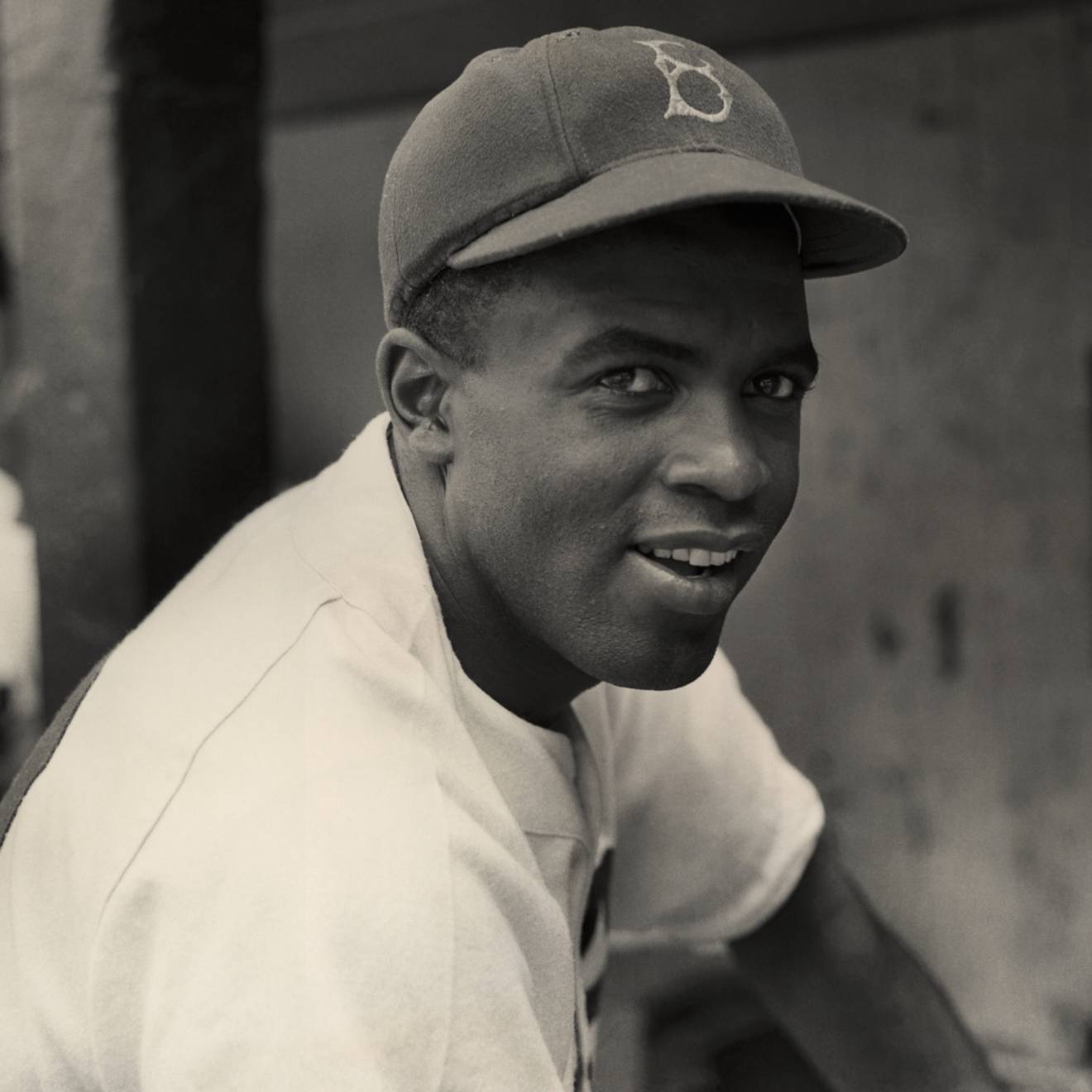 Jackie Robinson smiles in his Brooklyn Dodgers uniform