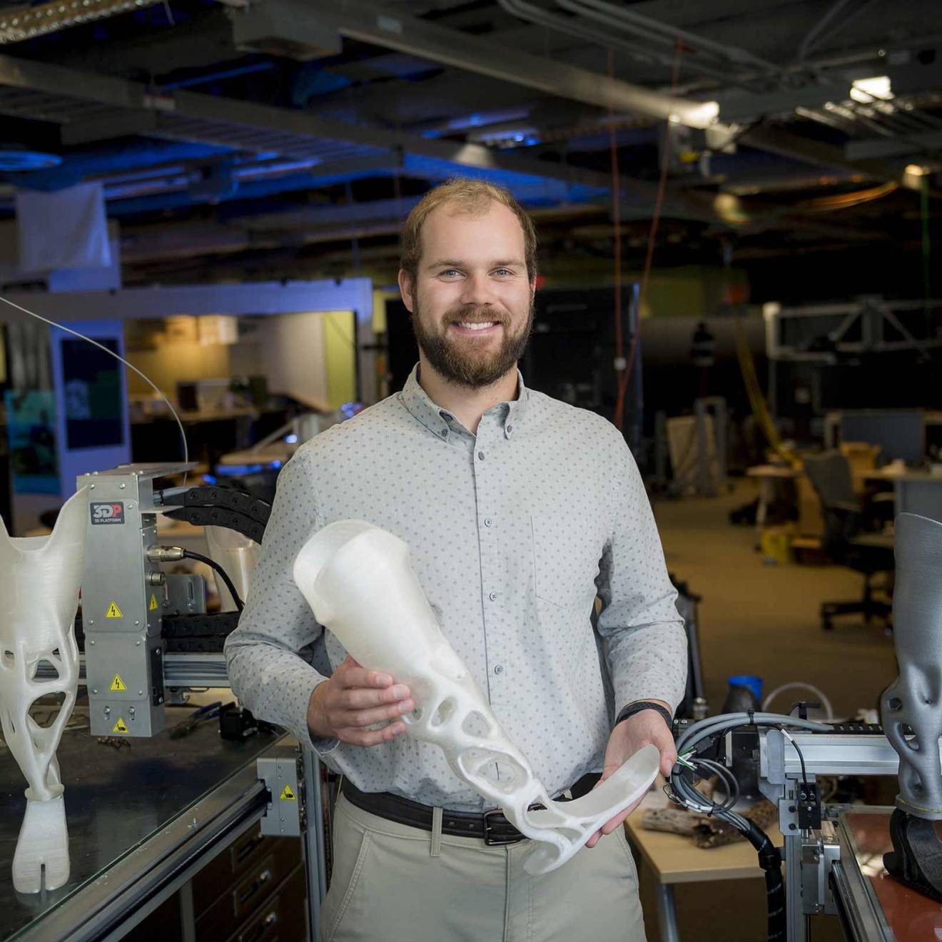 Joshua Pelz holding a 3D-printed prosthetic