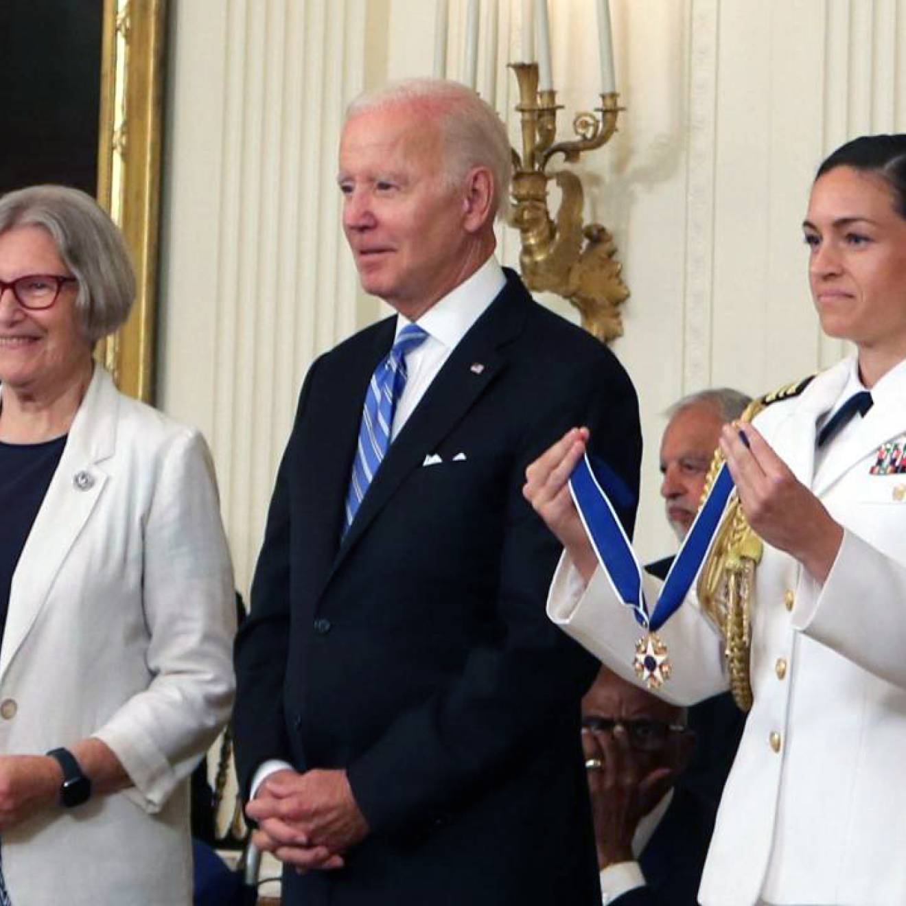 Sister Simone, President Biden and a woman in a Navy officer holding the Presidential Medal of Freedom