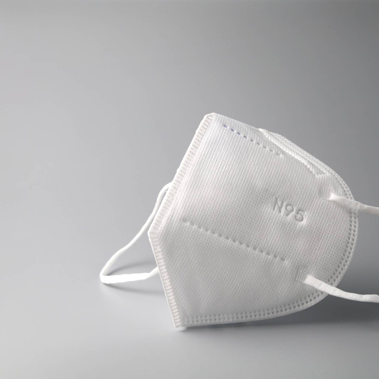 N95 mask on grey background