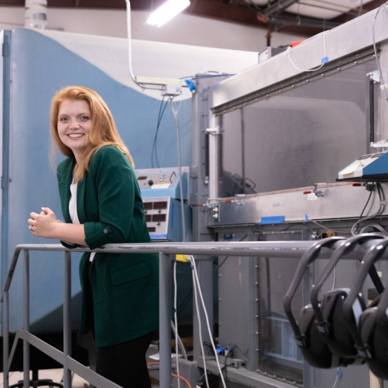 Young woman with red hair and a green cardigan in a laboratory