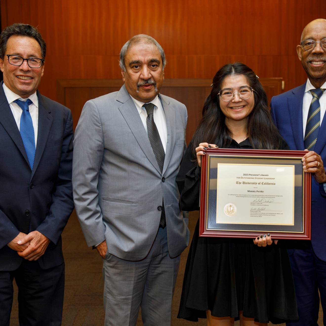 Chair Richard Leib, Chancellor Khosla, a young Latina woman Maribel Patiño, and President Drake 