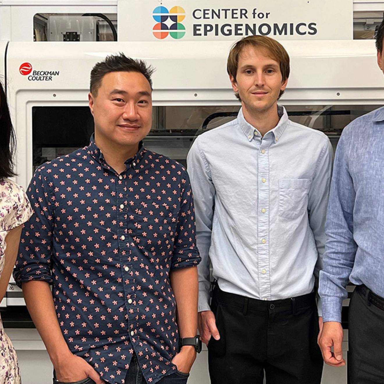 Four scientists standing together, three men one woman