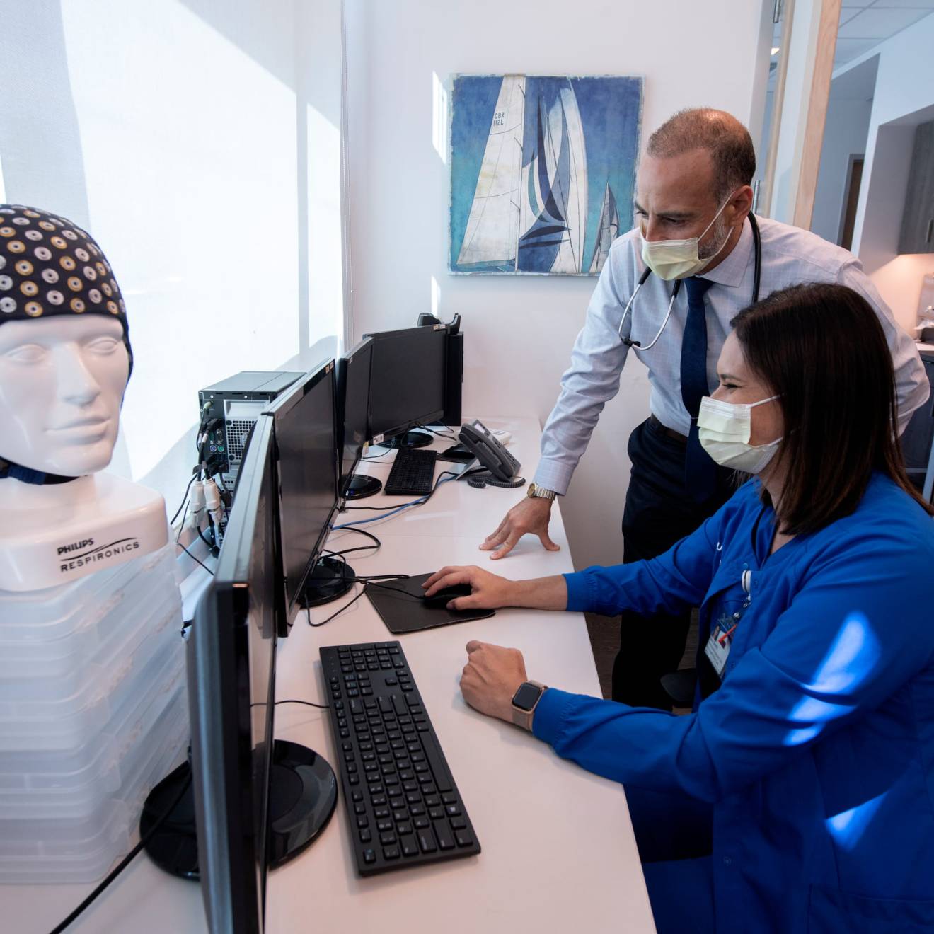 Two medical professionals looking at a computer together