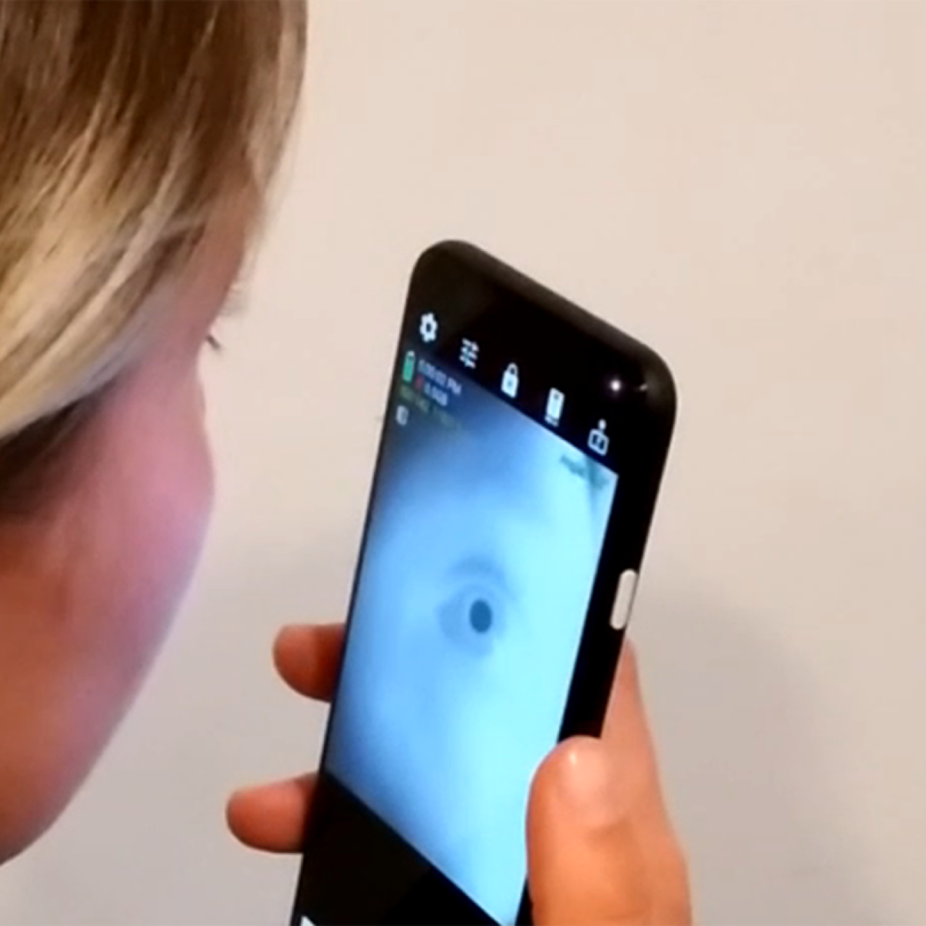 Woman looking into an app that shows her eye