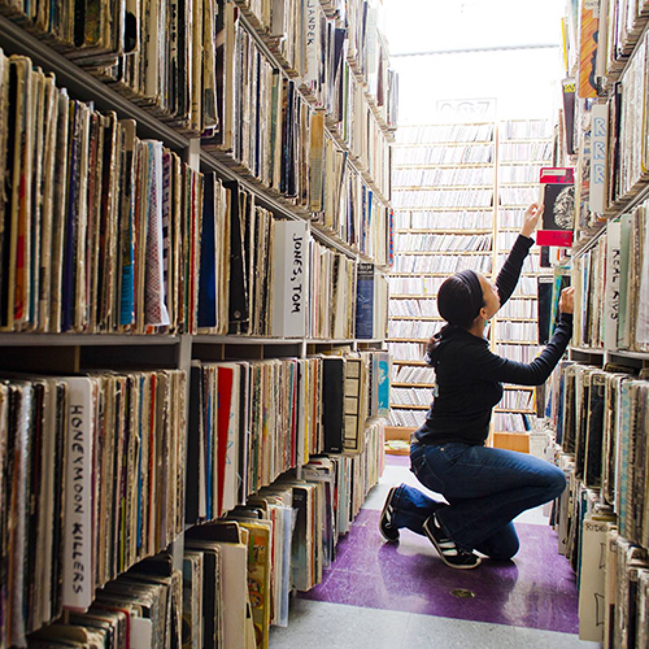 Student looks through the music archive of KALX on the UC Berkeley campus
