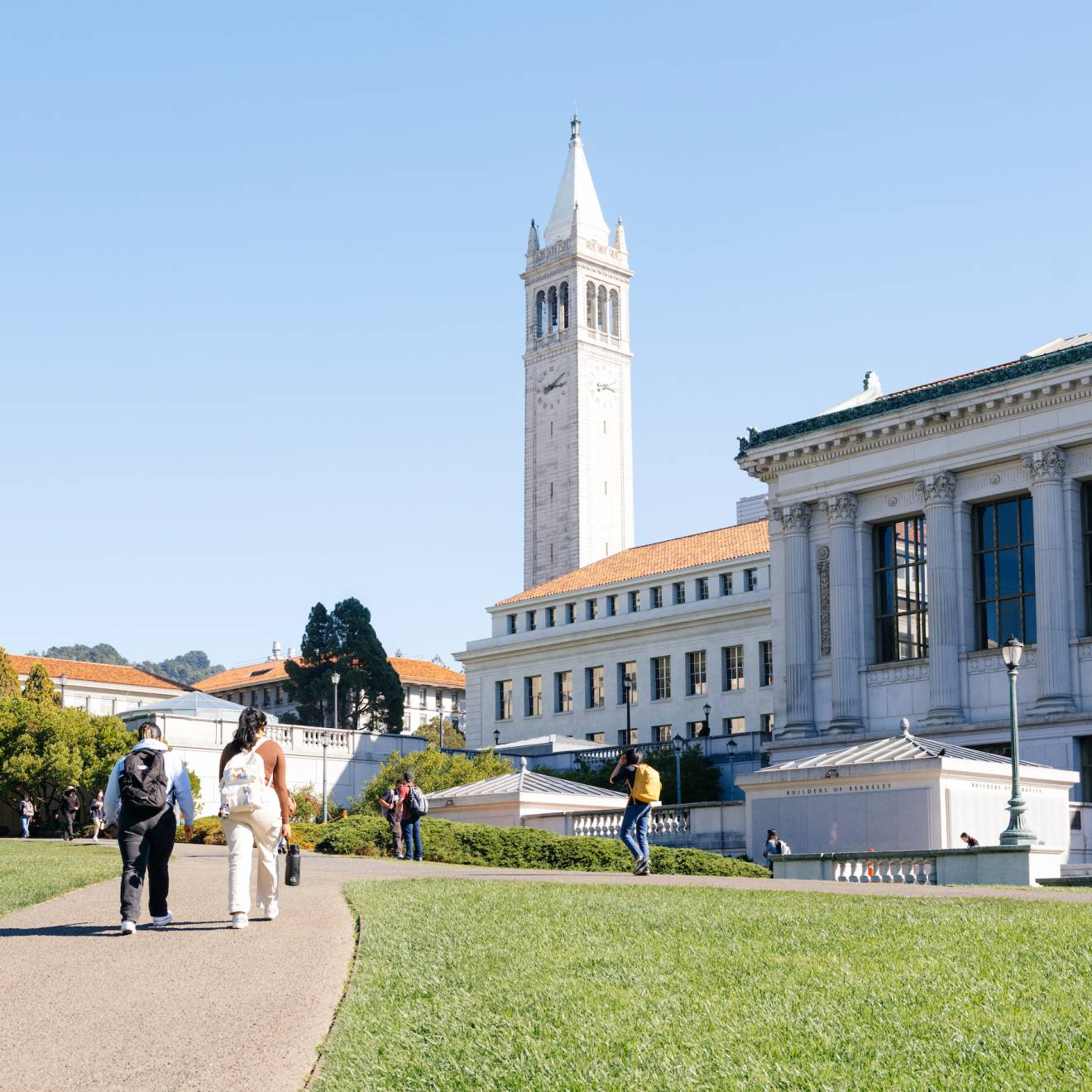 A view of students walking on the UC Berkeley campus on a clear day, Sather Tower ahead