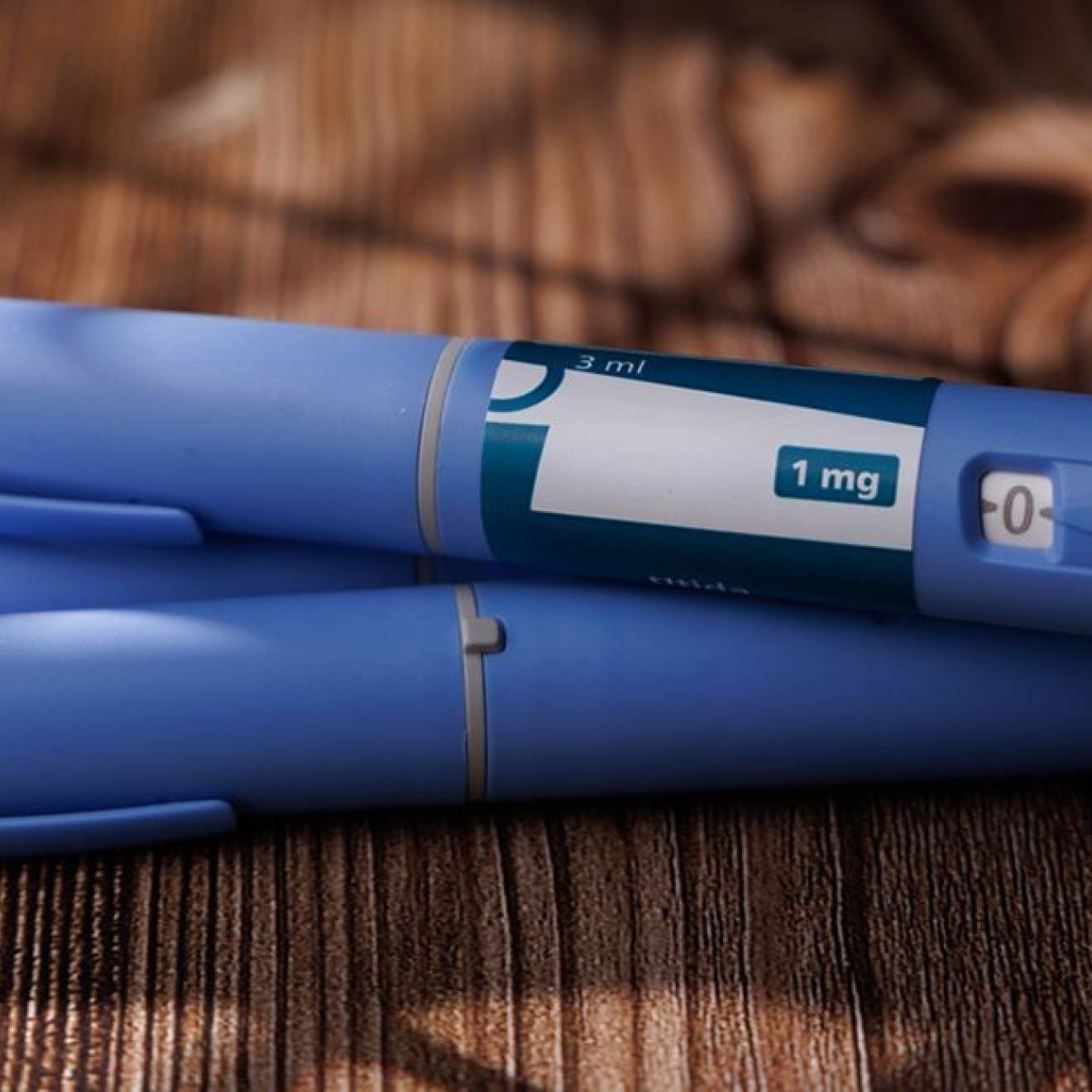 A set of three blue GLP-1 pens