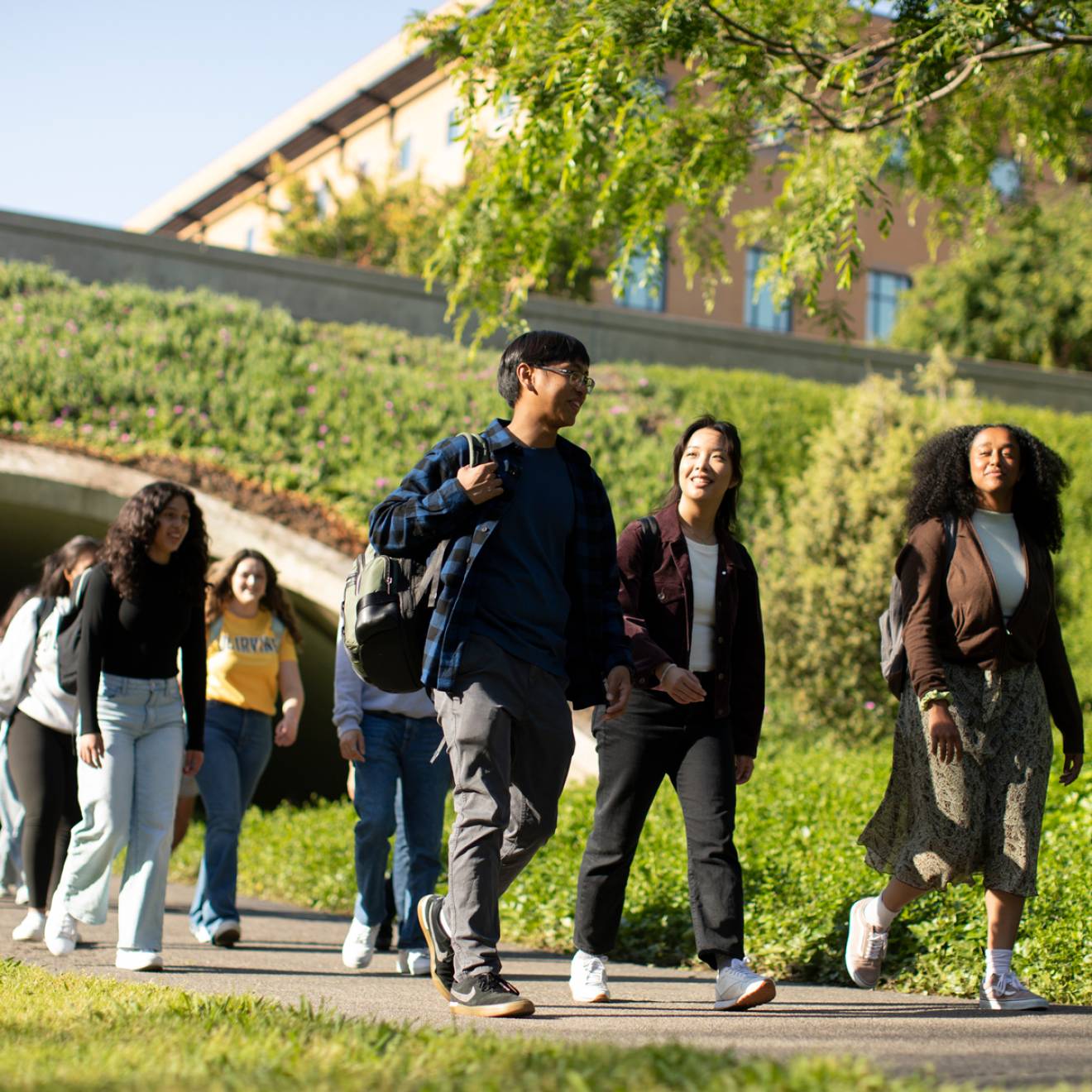 Group of diverse students walking on UC Irvine campus