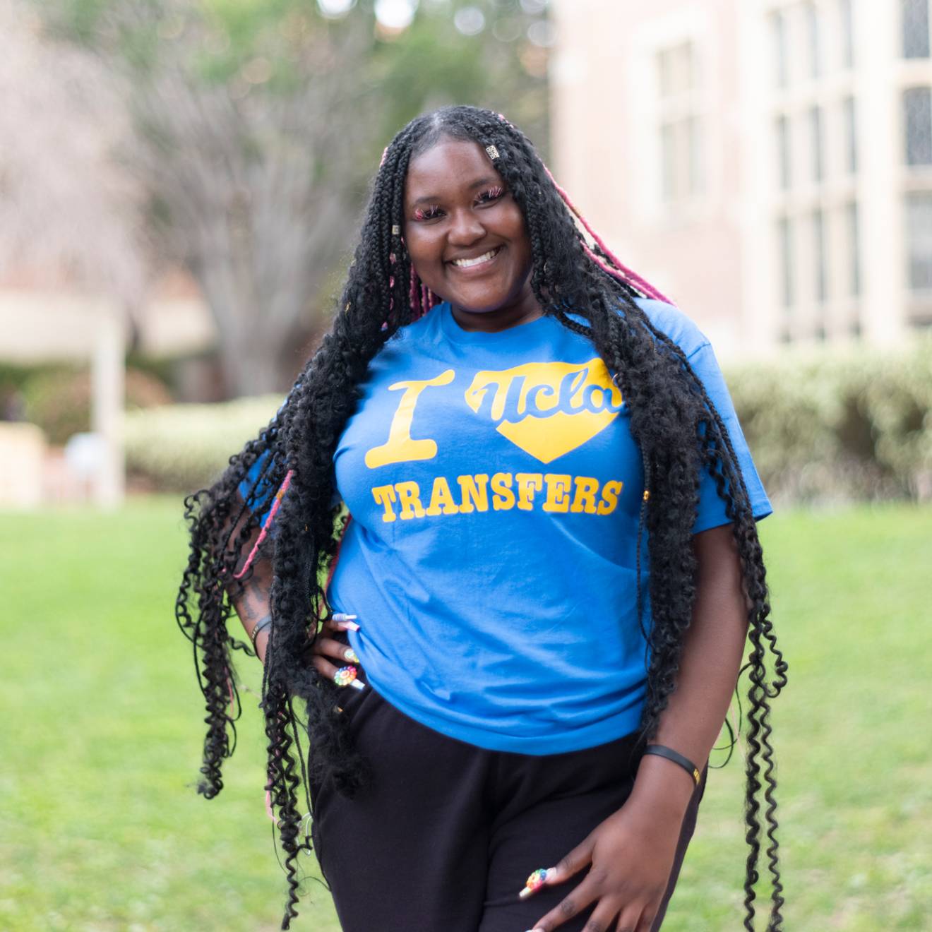 Black woman smiling with a T-shirt that says I UCLA-heart Transfers