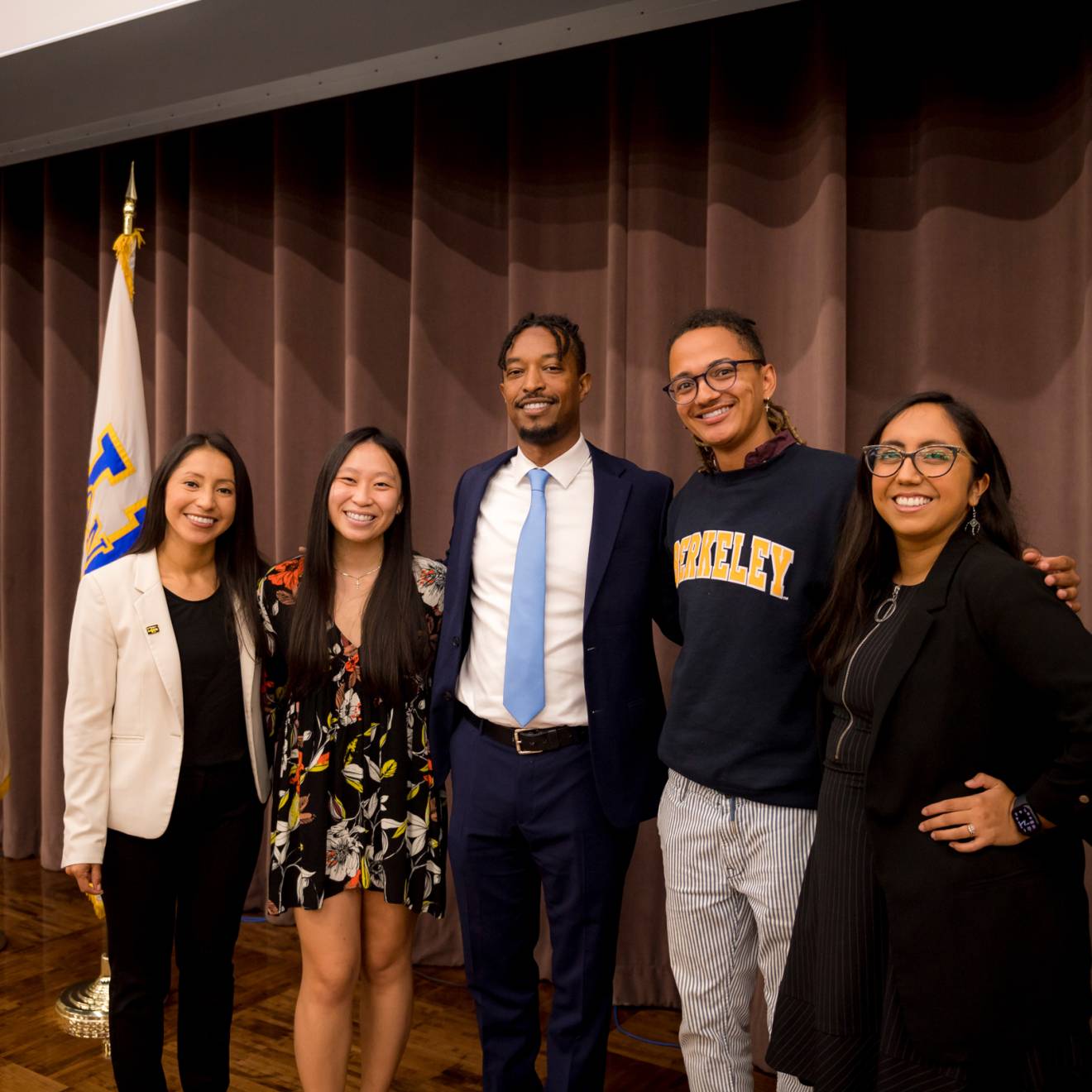 From left to right, current Student Regent Marlenee Blas Pedral, Mary Tran, Student Regent-designate Merhawi Tesfai, William Carter and Deniss Martinez posing for photo in a conference room