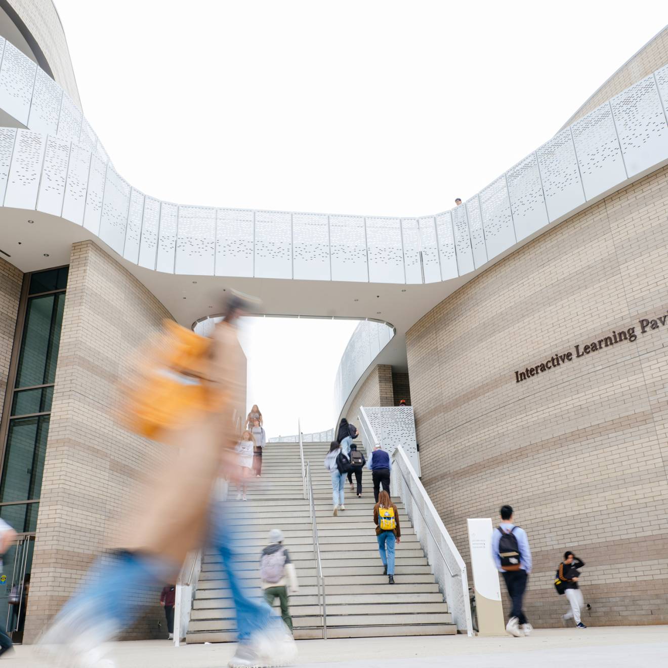 Students walk on the UC Santa Barbara campus in front of the Interactive Learning Pavilion