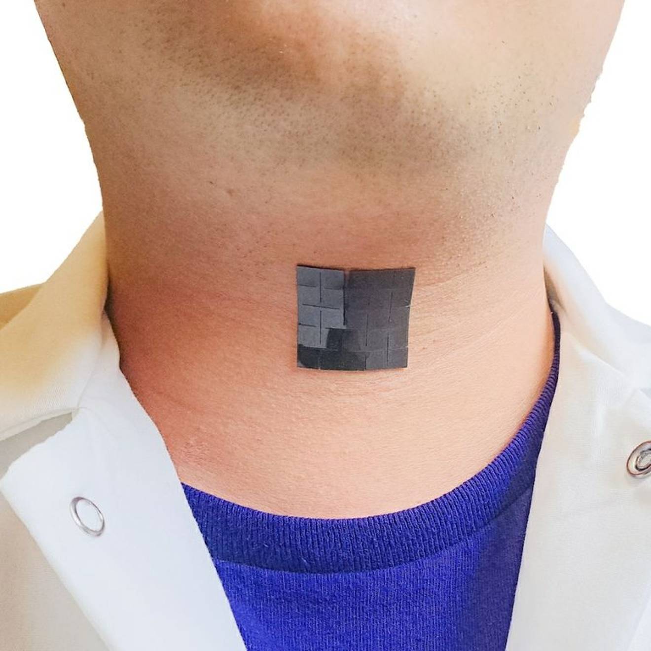 A black patch in the middle of a person's neck