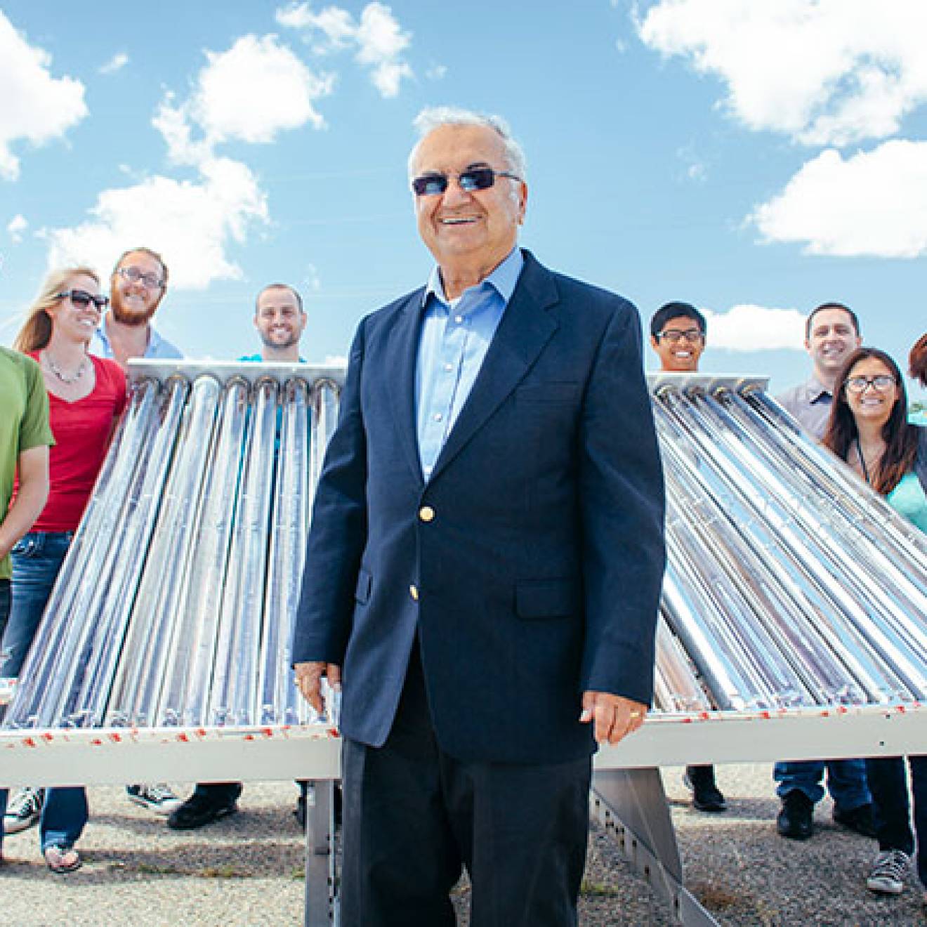 Professor Roland Winston and some of his student researchers and their solar collector. Winston in front