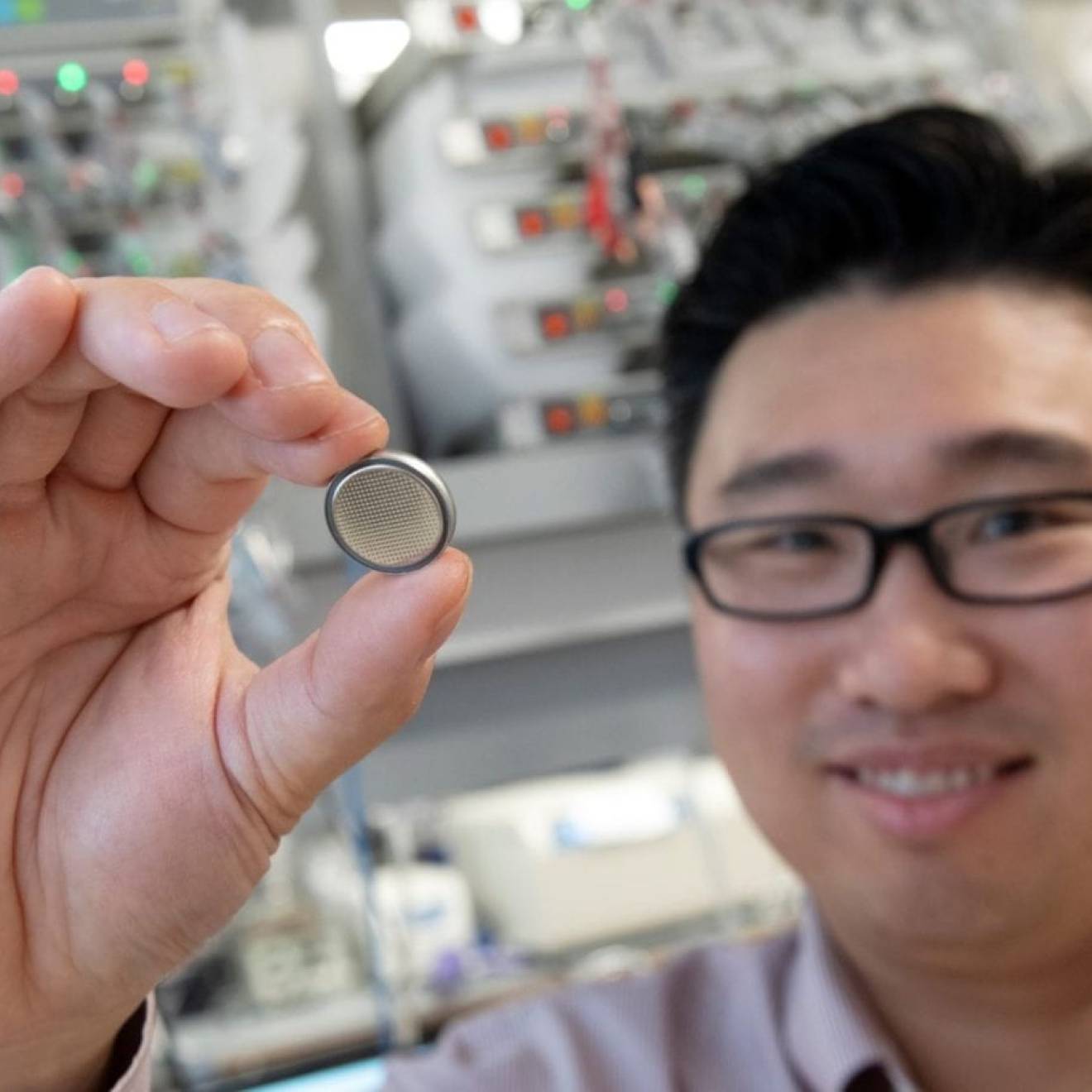 Huolin Xin, UC Irvine professor of physics & astronomy, holds up a small battery