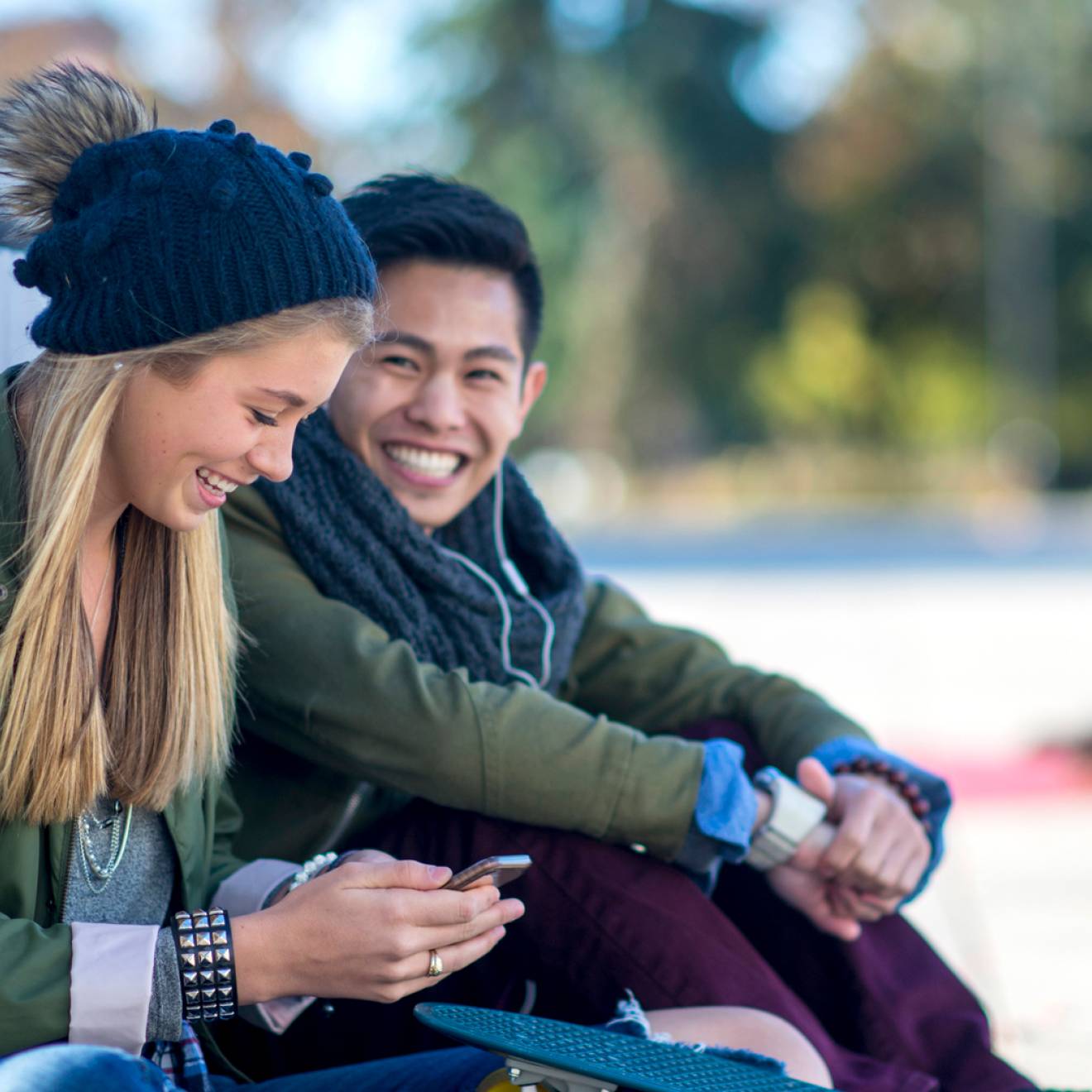 Young man smiling at a young woman
