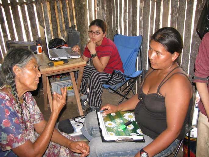 Two women interviewing Tsimane woman