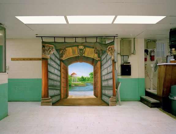 Landscape painting hung in a prison hallway