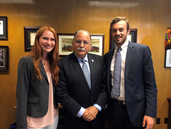 Assemblymember Jose Medina with two student ambassadors