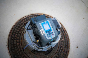 Wastewater sampler on a manhole