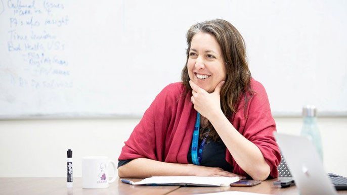 Christina Mangurian sits in classroom