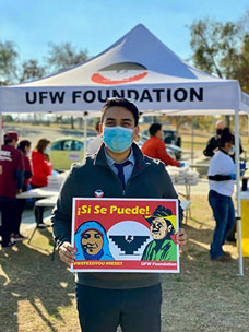 Osorio holds up a UFW sign at a recent union event in Bakersfield